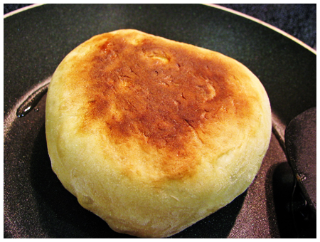 Home-made english muffin on the griddle