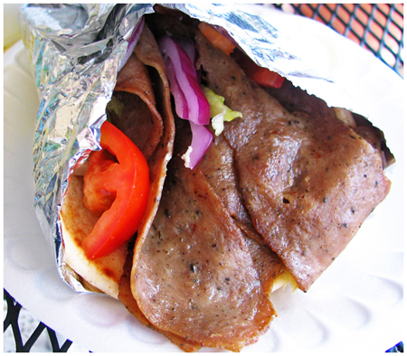 Gyro with lamb, lettuce, tomatoes, red onions, tzatziki sauce